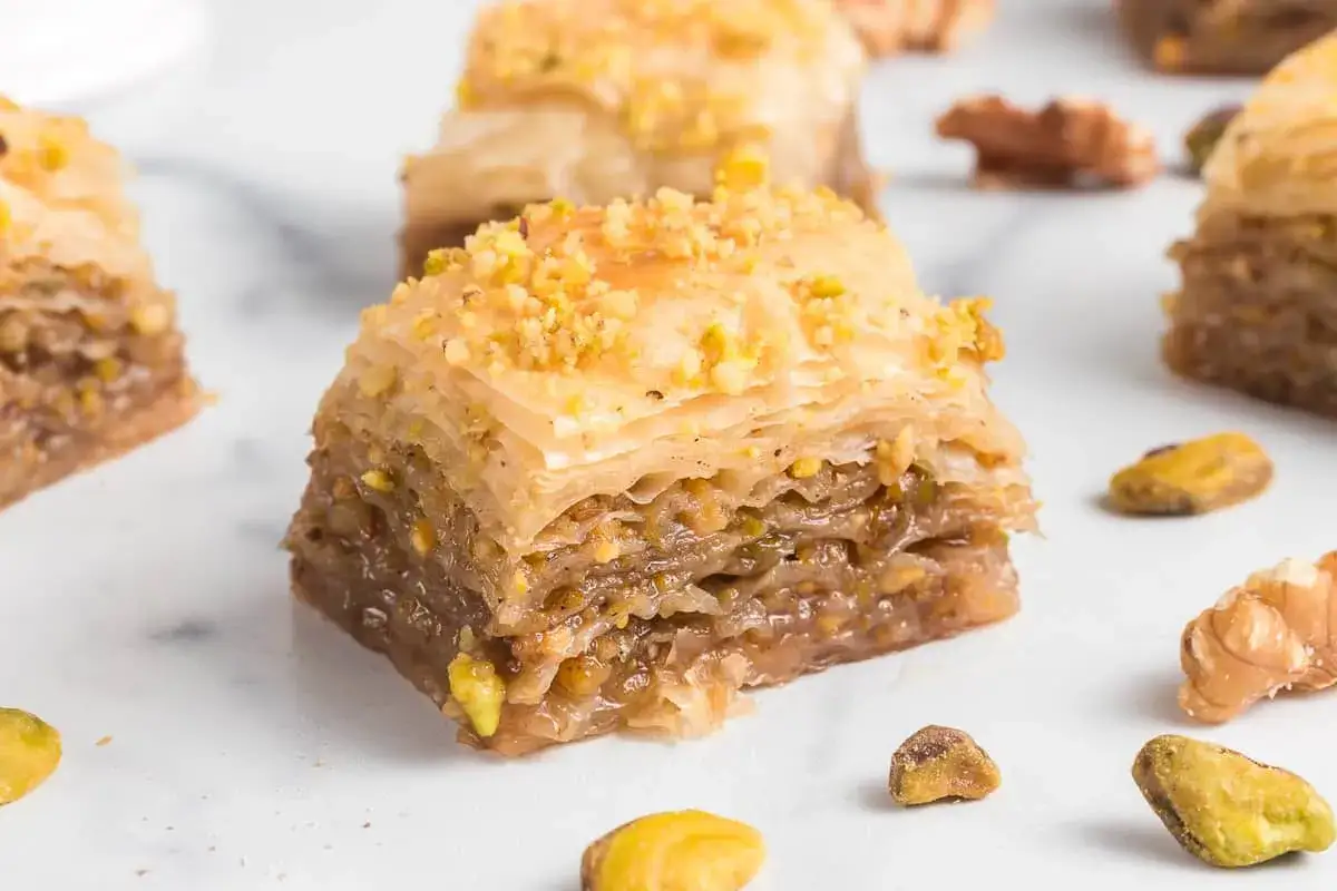 Słodka baklava co to? Warstwy ciasta filo z orzechami i syropem, posypana pistacjami. Pyszny deser.