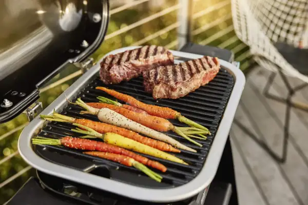 Dwa soczyste steki i kolorowe marchewki na grillu. Idealne na letnie wieczory, zgodnie z naszymi sprawdzonymi przepisami na grilla.